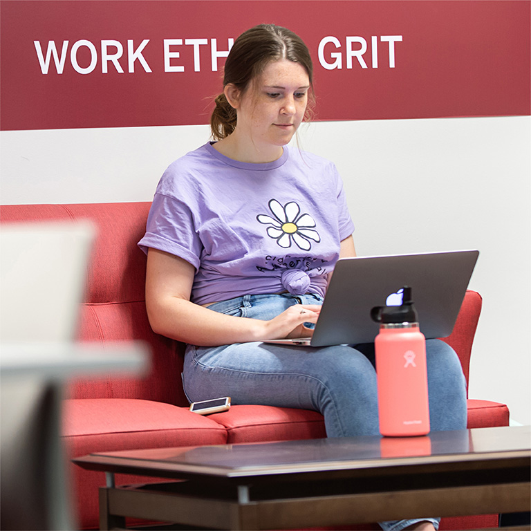 Student working on her laptop in the Walter Center